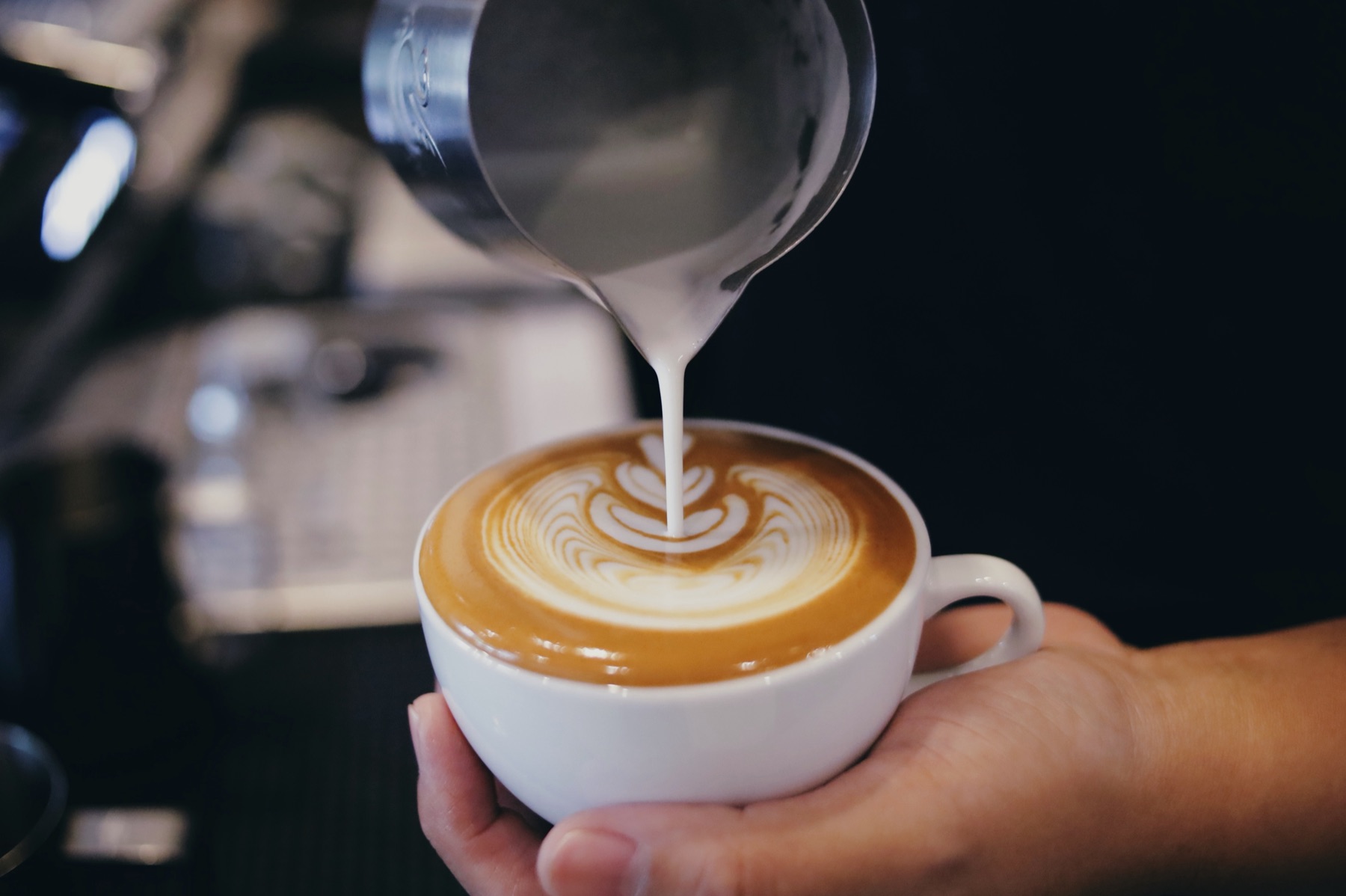 Milk being poured into a coffee